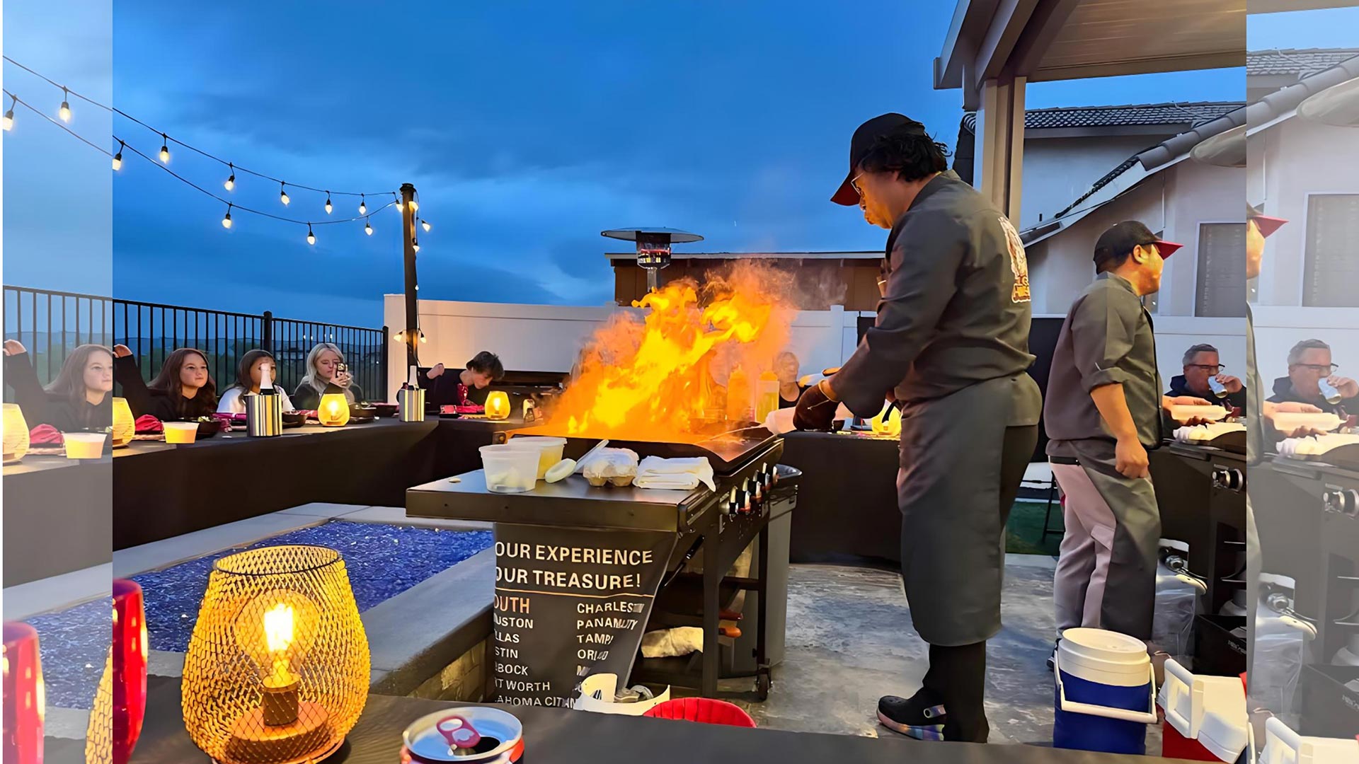 A lively family gathering featuring a professional chef providing hibachi at home catering services.